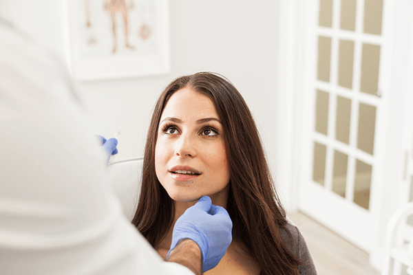 Brunette woman in a consultation with a plastic surgeon