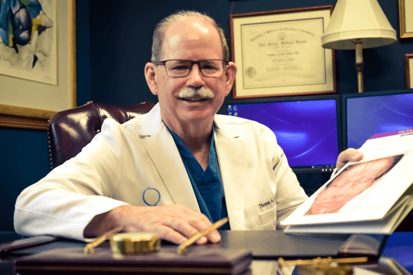 Dr. Leach performing aconsultation with at his office