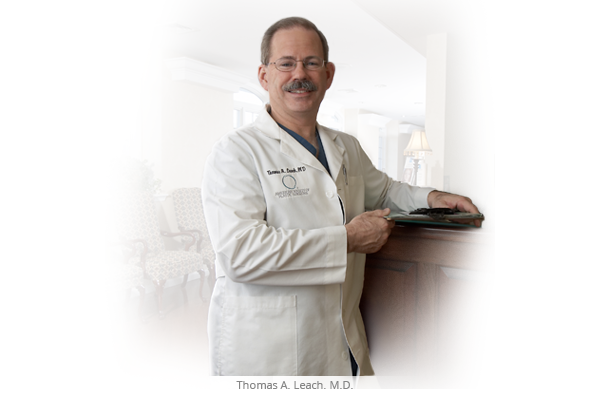 Dr. Thomas Leach, Medical Director standing at a desk