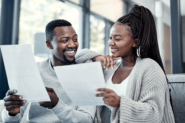Attractive African American couple looking over financial paperwork