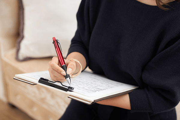 Female patient filling out a medical form