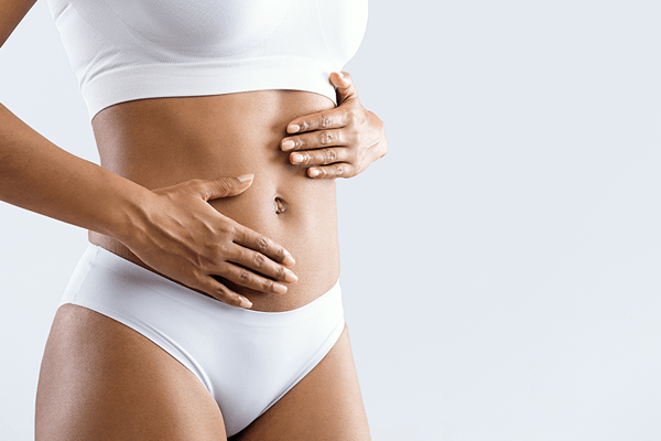 Close up of an African American woman touching her fit abdomen