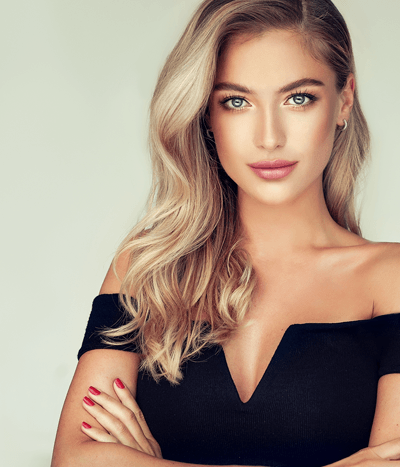 Portrait of a young blonde elegant woman in a black evening gown